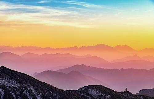 Image shows mountain landscape immersed in various colour.